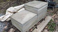 Stack of concrete patio stones, side view showing multiple layers