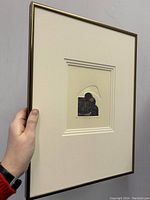 Framed view of Mathias Muleme "The Love Song" intaglio print held upright, showing the dimensions and presentation.