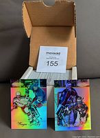 Open box showing a large quantity of glossy hockey cards in sleeves, top card featuring Wayne Gretzky and goalie card from 1998-99 Topps Gold Label set