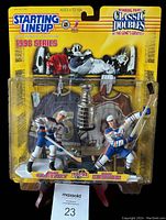 Overall view of sealed 1998 Starting Lineup Classic Doubles set featuring Wayne Gretzky and Mark Messier figurines and Stanley Cup trophy in original blister card packaging.