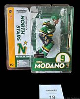 Front view of sealed Mike Modano figurine in original packaging with Minnesota North Stars graphics and McFarlane branding visible.