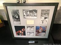 Full view of the framed collection showing the autograph and seven surrounding photos of Bob Cousy in action.