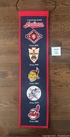 Full length of Cleveland Indians wool logo banner showing all five historic logos and red border.