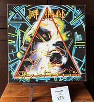 Front cover of Def Leppard Hysteria vinyl LP showing colorful graphic art and band logo.