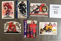 Photo of 7 autographed NHL hockey cards featuring players Daniel Alfredsson, Henri Richard, Sergei Fedorov, Alexei Yashin, Trevor Linden, Ed Olczyk, and an unidentified card