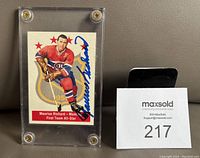 Front view of Maurice "Rocket" Richard signed hockey card in protective case showing full autograph and clear card details.