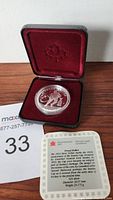 1993 Silver Proof Coin in black case with red velvet lining and Canadian maple leaf embossing inside lid. Coin presented alongside Royal Canadian Mint certificate card with descriptive text.