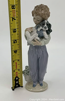 Front view of figurine with measuring tape showing height around 7 inches