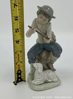 Front view of Lladro figurine with measuring tape showing height about 6.5 inches.