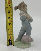 Front view of the Lladro figurine with measuring tape indicating approximately 6.5 inches tall