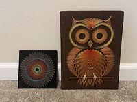 Two string art pieces, one owl design on brown board and one circular design on black board, shown side by side.