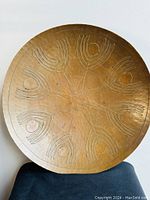 Top view of the round copper bowl showing the detailed engraved pattern
