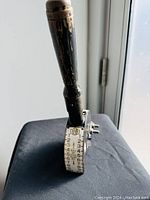 Front view showing wooden handle, numbered dial with 'HUBB', and age wear.