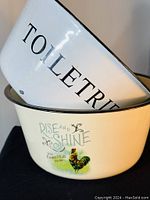 Both bowls stacked to show text "TOILETRIES" on one and "RISE AND SHINE" with rooster on the other