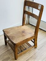 Front view of vintage oak posture seat chair showing rectangular backrest and seat.