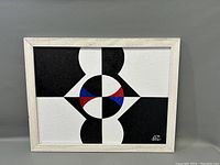 Full view of the framed acrylic abstract painting with geometric shapes and color accents.