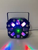 Front view of Chauvet Swarm 5FX DJ lighting effect fixture in operation projecting colorful lights including red, blue, and purple.