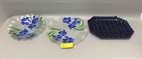Three fused glass items placed side by side: round tray, octagonal tray, and bowl, showing size and design variation.
