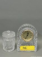 Front view showing both the Waterford cut crystal dome clock and the cylindrical sugar jar with lid side by side.
