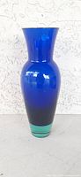 Front full view of the royal blue glass vase with green base.