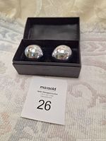 Pair of chrome steel Baoding balls in black presentation box on fabric surface
