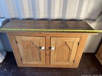 Front view of sideboard with tape measure across top showing overall width (~60 inches)