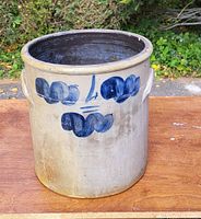 Front view of large crock showing blue painted decoration on cream background.
