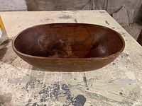 Top view of oval wooden bowl showing smooth interior and wood grain.