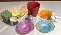 Photo of colorful glass bowls, red pot, and three candles showing set contents