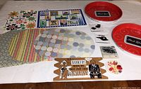 All items arranged on table including two red round Carling Black Label trays, colorful vintage plastic placemats in floral, striped, circle patterns, acrylic coasters, and decorative sign.