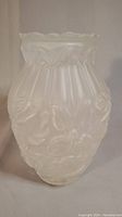 Full side view of satin glass vase showing rose relief pattern and vertical ribs.
