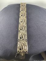 Full view of bracelet laid flat showing series of rectangular openwork filigree panels
