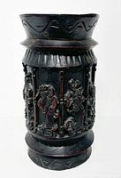 Full view of the vintage Chinese ebony vase/holder showing cylindrical shape, carved figures, and decorative top edge.