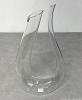 Crystal glass decanter with distinctive dual necks and elegant curved design, 15 inches tall.