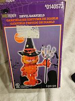 Box showing branded image of Garfield dressed as a devil character in Halloween decoration. Box states 30 inches tall and item number 0140573.