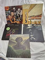 Vintage vinyl records spread out showing album covers by David Bowie, Quincy Jones, Harold Melvin & The Blue Notes, and a soundtrack album.