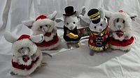 Five Christmas mice figurines arranged in a group, displaying their festive costumes and sizes