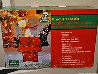 Photo of original box showing Peanuts Snoopy Pre-Lit Yard Art with details including height 36 inches and 100 lights.