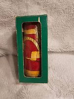 Original green box with plastic window showing one Santa nesting doll inside.