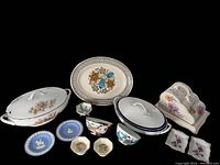 Wide view of entire lot showing covered casseroles, trinket plates, cheese holder, and small decorative bowls