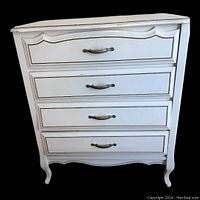 Front view of white French Provincial highboy dresser showing four drawers with metal handles and decorative molding.