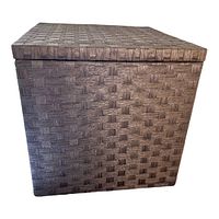Front angled view of one storage ottoman showing woven basket pattern and lid