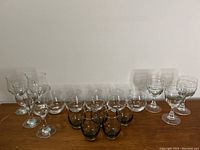 Overview of 4 clear wine glasses, 5 smoke grey glasses, and 3 Irish coffee glasses showing variety of shapes and styles.