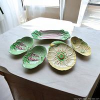 Overview photo showing all five vintage Carletonware serving plates arranged on a white table with natural lighting.