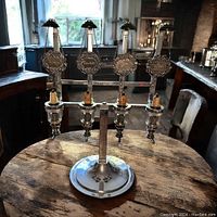 Full front view of the Gaskell and Chamber 4 bottle liquor dispenser with all four bottles labeled Gin, Vodka, Scotch, Bourbon, showing silver plaques and dispensing mechanisms.