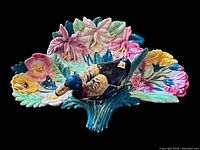 Front view showing the bright leafy and floral 3-section ceramic dish with colorful majolica glaze