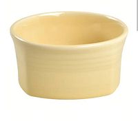 Front angle photo of square ivory ceramic bowl showing ribbed texture and curved square shape