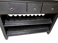 Close-up of three drawers with ring pull handles and detailed view of two wine bottle shelves, one removable