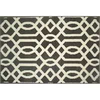 Top view showing brown rug with white geometric pattern in rectangular shape.