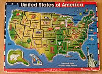 Front view of the complete usable puzzle showing colorful state pieces with names, capitals, and illustrations.